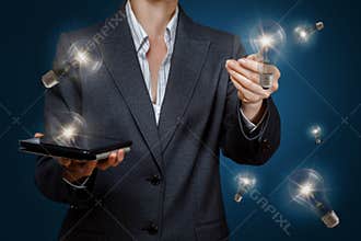 A businesswoman is operating with set of innovative idea lightbulbs
