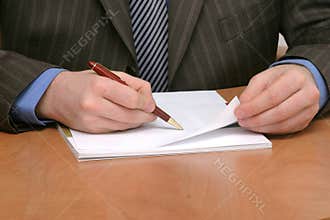 Business man writing on blank paper