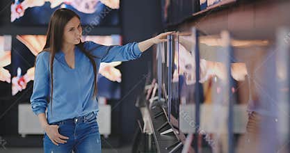 Woman buying TV in a store. 4K UHD.