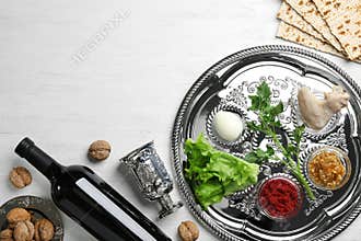 Flat lay composition with symbolic Passover Pesach items and meal on wooden background