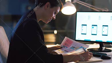 Ui designer working on interface at night office
