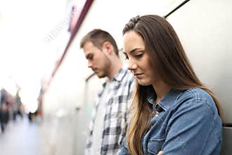 Sad couple or friends complaining in the street