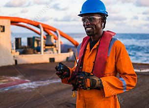 Seaman AB or Bosun on deck of vessel or ship , wearing PPE