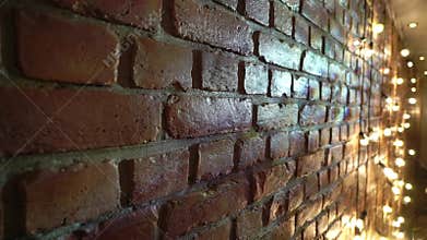 Wal with red brick in loft apartment with garlands