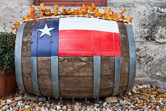 Wooden oak barrel with Texas flag painted on/ Decorative oak barrel in front of winery