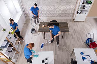 Elevated View Of Janitors Cleaning The Office