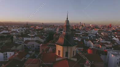 Amazing sunset over red tile roofs of big city