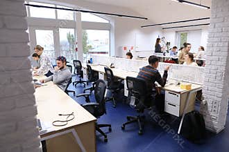 Office space in middle of working day with people immersed in wo