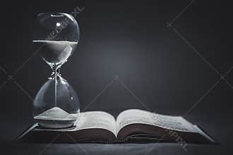 Hourglass on a Bible