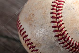 A baseball on an old wood table, sport