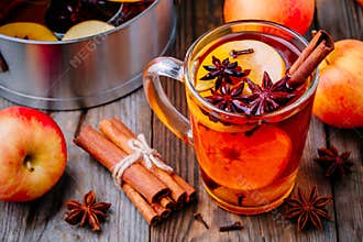 Hot mulled apple cider with cinnamon sticks, cloves and anise