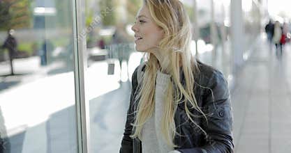 Pretty woman looking at shop-window