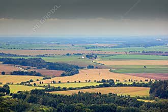 Kokorinsko, Czech Republic. Fields, meadows, with clouds. Beautiful morning landscape. Village below the hill. Landscape with fiel