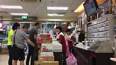 Motion of people line up for paying food at 7 eleven check out counter