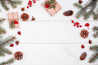 Christmas background with Christmas gift, fir branches, pine cones, snowflakes, red decorations. Xmas and Happy New Year
