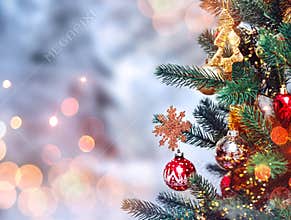 Christmas tree background and Christmas decorations with snow, blurred, sparking, glowing.