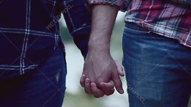 Close up of two lovers joining hands. Detail silhouette of man and woman holding hands over. couple trust, love and