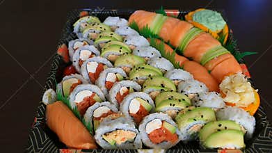 Video of a platter of sushi rolls with both raw and cooked ingredients 1080p HD