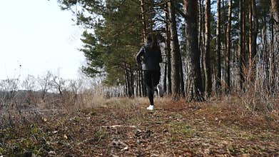 Fitness workout outdoors. Sport woman running through the woods.