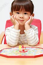 Japanese girl playing with boardgame