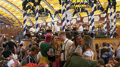 Orchestra band plays inside a large beer tent at the Oktoberfest Festival. Bavaria, Germany