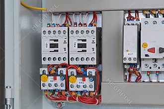 Magnetic starters with thermal relays connected by wires.