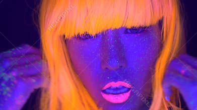 woman with UV fluorescent face and body makeup