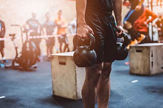 Man training with kettlebell in functional fitness gym