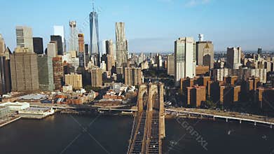 Aerial view of the Brooklyn bridge in New York, USA, going to the Manhattan district. American flag waving on the wind.