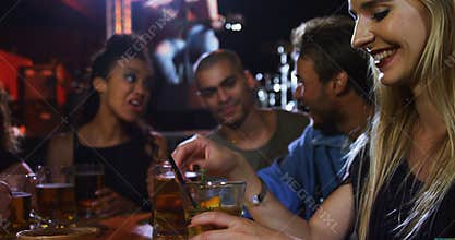 Woman having fun while drinking cocktail