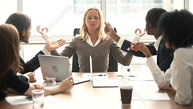 Calm businesswoman meditating at meeting with multiracial colleagues, no stress