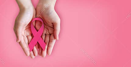 Pink ribbon on hands for breast cancer awareness