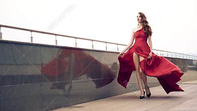 Beautiful woman in red fluttering dress.