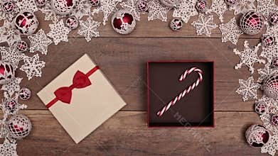 Hands opening christmas present revealing a candy cane gift