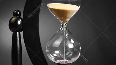 Time, the hourglass turns the hand and begins the countdown of five minutes in black and white shades