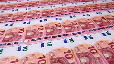 Camera sliding over small euro banknotes layer