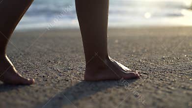 Woman walking on the sandy beach