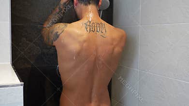 Attractive Young Muscular Man Taking Shower
