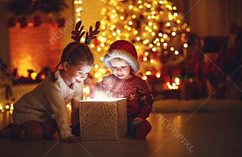 Merry Christmas! happy children with magic gift at home