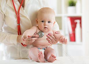 Doctor pediatric examining little child in clinic. Baby health concept
