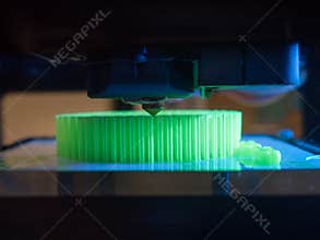 Printer printing a green 3d object