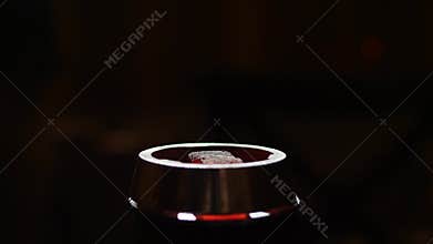 Putting of coal on hookah bowl in slow motion in 4k in darkness closeup