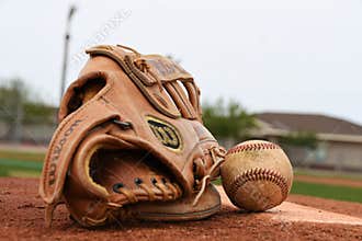 Baseball Glove and Baseball On A Pitching Mound.