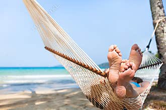 Happy couple family in hammock on tropical paradise beach, island holidays
