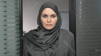 A young Arab girl in a hijab is surprised, indignant and looks at the camera. 60 fps
