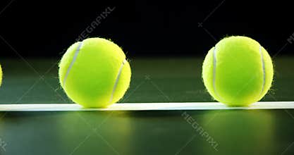 Tennis balls arranged on white line 4k