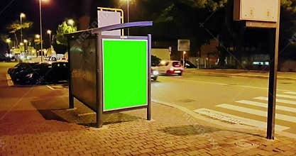 Billboard with a chroma key green screen on a traffic cars city night street, light night, advertisement