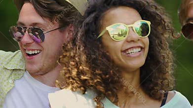 Multicultural group of friends enjoying music festival outdoors, happiness