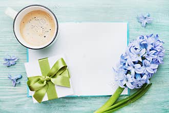 Mothers Day spring holiday card with empty notebook for greeting text with cup of coffee, gift or present box and hyacinth flowers