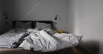 Interior of bedroom with unmade bed